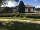 Landscaped front yard with manicured hedges and colorful flowers at 3036 Seigneury Dr, Windermere, FL 34786