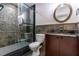 Bathroom featuring tiled shower with glass door and wood cabinets at 1860 Via Contessa, Winter Park, FL 32789