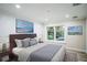 Serene bedroom with soft lighting, neutral tones, a large window with greenery, and elegant decor at 1860 Via Contessa, Winter Park, FL 32789