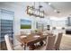 Dining room with wood table and view of the kitchen at 1860 Via Contessa, Winter Park, FL 32789