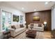 Inviting living room with neutral sofas, stylish wood accent wall, and bright natural light at 1860 Via Contessa, Winter Park, FL 32789