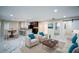 Spacious living room with marble floors, modern furniture, and an open-concept kitchen in the background at 1860 Via Contessa, Winter Park, FL 32789