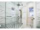 Glass shower with large tiles and a gray-and-white patterned floor at 1860 Via Contessa, Winter Park, FL 32789