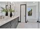 Modern bathroom featuring double sinks, black cabinets, stylish lighting, and a standalone tub at 3480 Fairway Ln, Orlando, FL 32804
