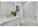 Modern bathroom with white tile shower, toilet, and vanity with marble countertop at 3480 Fairway Ln, Orlando, FL 32804