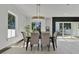 Bright and inviting dining room with a stylish chandelier, modern decor, and backyard view at 3480 Fairway Ln, Orlando, FL 32804