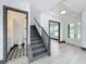 Entryway featuring hardwood floors, a staircase, and views into the powder room and other rooms at 3480 Fairway Ln, Orlando, FL 32804
