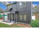 This modern home features vertical siding, a covered front porch, and well-maintained landscaping at 3480 Fairway Ln, Orlando, FL 32804