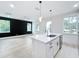 Open-concept kitchen with a center island, quartz countertops, and stainless steel appliances at 3480 Fairway Ln, Orlando, FL 32804