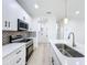 Clean white kitchen with stainless steel appliances and modern fixtures at 3480 Fairway Ln, Orlando, FL 32804