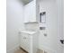 Clean laundry room with white cabinets and quartz countertops, plus washer and dryer hookups at 3480 Fairway Ln, Orlando, FL 32804
