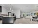 Bright, open-concept kitchen, dining and living space with hardwood floors and a modern design at 3480 Fairway Ln, Orlando, FL 32804