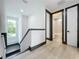 Upstairs hallway with hardwood floors, dark trim, and a view of the bathroom at 3480 Fairway Ln, Orlando, FL 32804