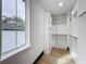 Bright walk-in closet featuring custom shelving, hanging rods, and hardwood floors at 3480 Fairway Ln, Orlando, FL 32804