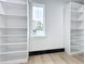 Bright walk-in closet or bedroom with built-in shelving units on both sides of a window at 3480 Fairway Ln, Orlando, FL 32804