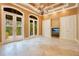 Elegant bonus room with coffered ceiling, chandelier, and travertine floors at 1400 Alabama Dr, Winter Park, FL 32789