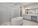 Elegant bathroom with soaking tub, walk-in shower, and double vanity at 16829 Bolsena Dr, Montverde, FL 34756