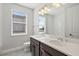Modern bathroom with double vanity and a large mirror at 16829 Bolsena Dr, Montverde, FL 34756