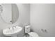 Simple half bathroom with pedestal sink and toilet at 16829 Bolsena Dr, Montverde, FL 34756