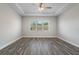 Bright bedroom with wood-look floors and ceiling fan at 16829 Bolsena Dr, Montverde, FL 34756