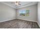 Bright bedroom with wood-look floors and ceiling fan at 16829 Bolsena Dr, Montverde, FL 34756