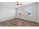 Light-filled bedroom featuring wood floors and two windows at 16829 Bolsena Dr, Montverde, FL 34756