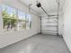 Clean garage with automatic door opener and epoxy floor at 16829 Bolsena Dr, Montverde, FL 34756