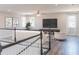 Spacious loft area with hardwood floors and a TV at 16829 Bolsena Dr, Montverde, FL 34756
