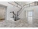 Impressive, dark-stained staircase with white railings in a two-story home at 16829 Bolsena Dr, Montverde, FL 34756