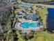 Aerial view of community pool, playground, tennis courts, pond, and clubhouse on a sunny day at 17843 Golden Leaf Ln, Orlando, FL 32820