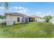 Large, green backyard with patio, shed, and generator on a sunny day at 17843 Golden Leaf Ln, Orlando, FL 32820
