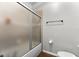 Bathroom featuring tile flooring, frosted sliding shower doors, and a mounted towel bar at 17843 Golden Leaf Ln, Orlando, FL 32820