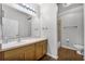 Neutral bathroom featuring wood flooring, white countertops, a large mirror, and a shower at 17843 Golden Leaf Ln, Orlando, FL 32820