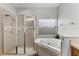 Bright bathroom with a corner soaking tub and separate shower with glass enclosure at 17843 Golden Leaf Ln, Orlando, FL 32820