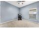 Bedroom showcasing a light-blue wall color and neutral carpeting, bathed in natural light at 17843 Golden Leaf Ln, Orlando, FL 32820