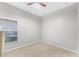 Bedroom showcasing neutral walls, carpet flooring, ceiling fan, and bright natural light at 17843 Golden Leaf Ln, Orlando, FL 32820