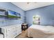 Bedroom with built in shelving, a white dresser, and a blue accent wall at 17843 Golden Leaf Ln, Orlando, FL 32820