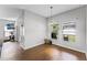 Cozy breakfast nook with wood-look tile floors, view from windows, and access to a patio and living area at 17843 Golden Leaf Ln, Orlando, FL 32820