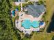 Overhead shot of the community pool, playground, clubhouse, and lounge area, surrounded by lush greenery at 17843 Golden Leaf Ln, Orlando, FL 32820