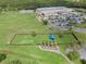Aerial view of the community dog park featuring mature trees, a shaded area, and green space at 17843 Golden Leaf Ln, Orlando, FL 32820