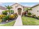 Well-maintained home with lush landscaping leading to a welcoming front entrance, perfect for curb appeal at 17843 Golden Leaf Ln, Orlando, FL 32820
