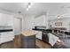 Open kitchen design with an island, stainless steel appliances, and a view into the living area at 17843 Golden Leaf Ln, Orlando, FL 32820