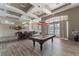 Well-lit recreation room with a pool table, seating, ceiling fans and access to outside pool area at 17843 Golden Leaf Ln, Orlando, FL 32820