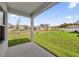 A view of the backyard and neighboring homes from the covered back porch at 8566 Caribbean Pine Way, Lakeland, FL 33809