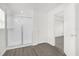 Bathroom features a glass shower stall with wood-look floors at 8566 Caribbean Pine Way, Lakeland, FL 33809
