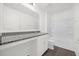 A well-lit bathroom with granite counters, white cabinets and a shower-tub combo at 8566 Caribbean Pine Way, Lakeland, FL 33809