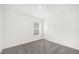 A view of a bedroom with neutral carpet and natural light from the window at 8566 Caribbean Pine Way, Lakeland, FL 33809