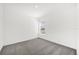 An empty bedroom features neutral carpet and a window for natural light at 8566 Caribbean Pine Way, Lakeland, FL 33809
