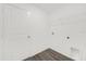A bright laundry room with overhead shelving and hookups ready for appliances at 8566 Caribbean Pine Way, Lakeland, FL 33809