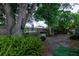 Backyard with large tree and landscaping at 809 Florida Pkwy, Kissimmee, FL 34743